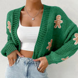 Green knitted cardigan with gingerbread appliqués — cozy holiday women’s sweater